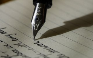 Pen writing on journal 